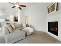 Bright living room with a fireplace, ceiling fan, and comfortable seating at 5172 Purple Mustard Ct, Brighton, CO 80601