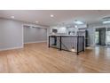 Bright open concept living room with hardwood floors, recessed lighting, and open access to the kitchen at 1601 S Glencoe St, Denver, CO 80222