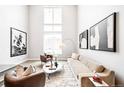 Bright and airy living room features soaring ceilings, large windows, and stylish decor at 1555 W 43Rd Ave, Denver, CO 80211