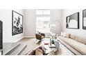 Stylish living room with a neutral color scheme, modern artwork, and bright natural light at 1555 W 43Rd Ave, Denver, CO 80211