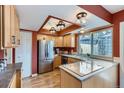 Well-lit kitchen with stainless steel appliances, ample cabinetry, and functional island at 431 S Balsam St, Lakewood, CO 80226
