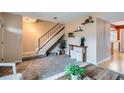 Bright living room with carpet, staircase, decorative shelves, and an open feel at 431 S Balsam St, Lakewood, CO 80226