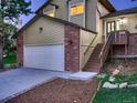Charming two-story home featuring a brick and siding exterior with a two-car garage and a wooden staircase at 8916 Sunridge Hollow Rd, Parker, CO 80134