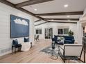 Bright living room with wooden beams, a shiplap accent wall, and large windows at 8916 Sunridge Hollow Rd, Parker, CO 80134