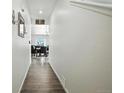 Bright hallway with wood flooring leading into the dining area, creating a seamless transition at 27504 E 1St Pl, Aurora, CO 80018