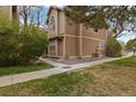 Cozy exterior view of a two story home with well-kept lawn and mature tree near sidewalk at 1770 S Quintero Way, Aurora, CO 80017