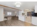 Bright living room featuring updated floors which flow into a modern kitchen at 1770 S Quintero Way, Aurora, CO 80017