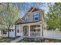 Charming two-story home boasts a welcoming front porch and beautifully maintained landscaping at 736 Trenton St, Denver, CO 80230