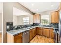 Well-lit kitchen featuring wooden cabinets, neutral countertops, and stainless steel appliances at 736 Trenton St, Denver, CO 80230