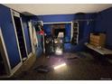 Bedroom with blue walls, patterned carpet, and unorganized décor at 10211 Ura Ln # 5-206, Thornton, CO 80260