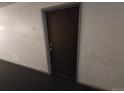 Brown door with gray door frame in a hallway at 10211 Ura Ln # 5-206, Thornton, CO 80260