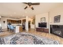 Open concept living room and kitchen area with hardwood floors and a fireplace at 6302 E 135Th Ave, Thornton, CO 80602