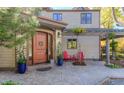 A welcoming entrance boasts a beautiful wood door, manicured landscaping, and a cozy seating area at 3737 26Th St, Boulder, CO 80304