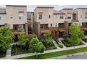 Contemporary townhomes with modern architecture and manicured landscaping at 8336 E 35Th Ave, Denver, CO 80238
