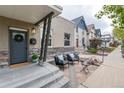 Inviting front porch with seating, featuring stone accents and pleasant neighborhood views at 3220 W 24Th Ave, Denver, CO 80211