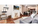 Bright living room featuring a fireplace, hardwood floors, and open concept design at 3220 W 24Th Ave, Denver, CO 80211