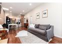 Comfortable living room with hardwood floors, an exposed brick accent wall, and an open floorplan at 3220 W 24Th Ave, Denver, CO 80211