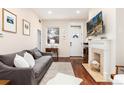 Relaxing living room features a decorative fireplace and a picturesque window view at 3220 W 24Th Ave, Denver, CO 80211
