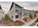 Beautiful two-story townhome featuring stone accents, landscaped front yard, and craftsman-style details at 9279 Merino Ct # D, Littleton, CO 80125