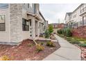 View of the townhome with low-maintenance landscaping and a walkway, providing an inviting approach at 9279 Merino Ct # D, Littleton, CO 80125
