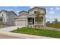 Charming two-story home featuring a covered porch, well-kept lawn, and an attached two-car garage at 42754 Calusa Pines Rd, Elizabeth, CO 80107