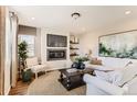 Cozy living room featuring a fireplace, TV, decorative shelves and stylish furniture on a nice rug at 42754 Calusa Pines Rd, Elizabeth, CO 80107