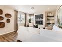 Comfortable living room with a sleek fireplace, modern decor, and large windows for natural light at 42754 Calusa Pines Rd, Elizabeth, CO 80107