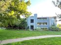 Exterior view of a multi-story condominium building with lush lawn, landscaping and walking path at 4676 White Rock Cir # 12, Boulder, CO 80301