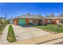 The charming exterior features a brick facade and a long driveway at 891 Ursula St, Aurora, CO 80011