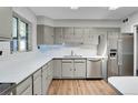 Bright kitchen features modern appliances and quartz countertops at 891 Ursula St, Aurora, CO 80011