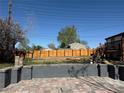 Large backyard with new wooden fence and deck with stairs, offering ample outdoor space at 2441 W 55Th Ave, Denver, CO 80221