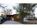 Charming remodeled home has new siding, a covered carport, and front porch with fresh landscaping at 2441 W 55Th Ave, Denver, CO 80221