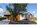 Charming home featuring a carport, covered front porch, and a well-maintained, landscaped yard at 2441 W 55Th Ave, Denver, CO 80221
