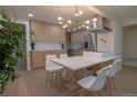 Bright kitchen features a modern chandelier, stainless steel appliances, and an island with white marble countertop at 2441 W 55Th Ave, Denver, CO 80221