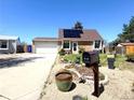 Charming single-Gathering home featuring a well-manicured front yard and solar panels on the roof at 4383 S Eagle Cir, Aurora, CO 80015