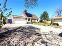 Spacious home featuring an attached garage, solar panels, and a driveway at 4383 S Eagle Cir, Aurora, CO 80015