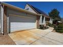 Front exterior view of home with attached garage and solar panels on the roof at 4383 S Eagle Cir, Aurora, CO 80015