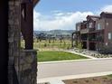 Exterior view of a townhome community featuring manicured landscaping and beautiful mountain views at 9662 Browns Peak Cir, Littleton, CO 80125