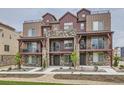 Beautiful townhome featuring a stone facade, balconies, and a modern architectural design at 9662 Browns Peak Cir, Littleton, CO 80125