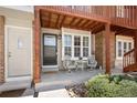 Inviting entrance with a cozy seating area on the porch and a charming welcome mat at 1148 S Ventura Cir # C, Aurora, CO 80017