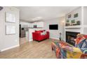 Bright living room featuring a cozy fireplace, hardwood floors, and an open floor plan at 1148 S Ventura Cir # C, Aurora, CO 80017