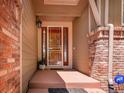 Inviting front porch with brick accents and a secure ADT system at 2485 Greensborough Cir, Highlands Ranch, CO 80129