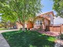Beautiful home exterior with well-manicured lawn and mature trees at 2485 Greensborough Cir, Highlands Ranch, CO 80129