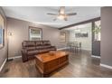 Open concept living and dining area with hardwood floors, ceiling fan, and plentiful natural light at 9450 Lillian Ln, Thornton, CO 80229