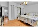 Bright bedroom with hardwood floors, white walls, and ensuite bathroom at 2580 Valley View Dr, Denver, CO 80221
