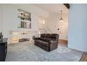 Bright living room with a vaulted ceiling and a comfortable leather sofa at 8144 W 81St Dr, Arvada, CO 80005