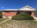Charming brick home featuring a well-maintained front yard with lush green shrubbery at 10885 Mildred Dr, Northglenn, CO 80233