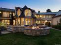 Backyard exterior featuring a stone fire pit and spacious patio; the perfect spot for outdoor entertaining at 5 Mockingbird Ln, Cherry Hills Village, CO 80113