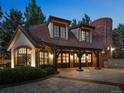 Detached garage features a stone facade, carriage doors, and ample parking space at 5 Mockingbird Ln, Cherry Hills Village, CO 80113