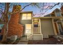 Charming home with red brick chimney, grey siding, and inviting front entry at 1981 S Hannibal Ct # B, Aurora, CO 80013